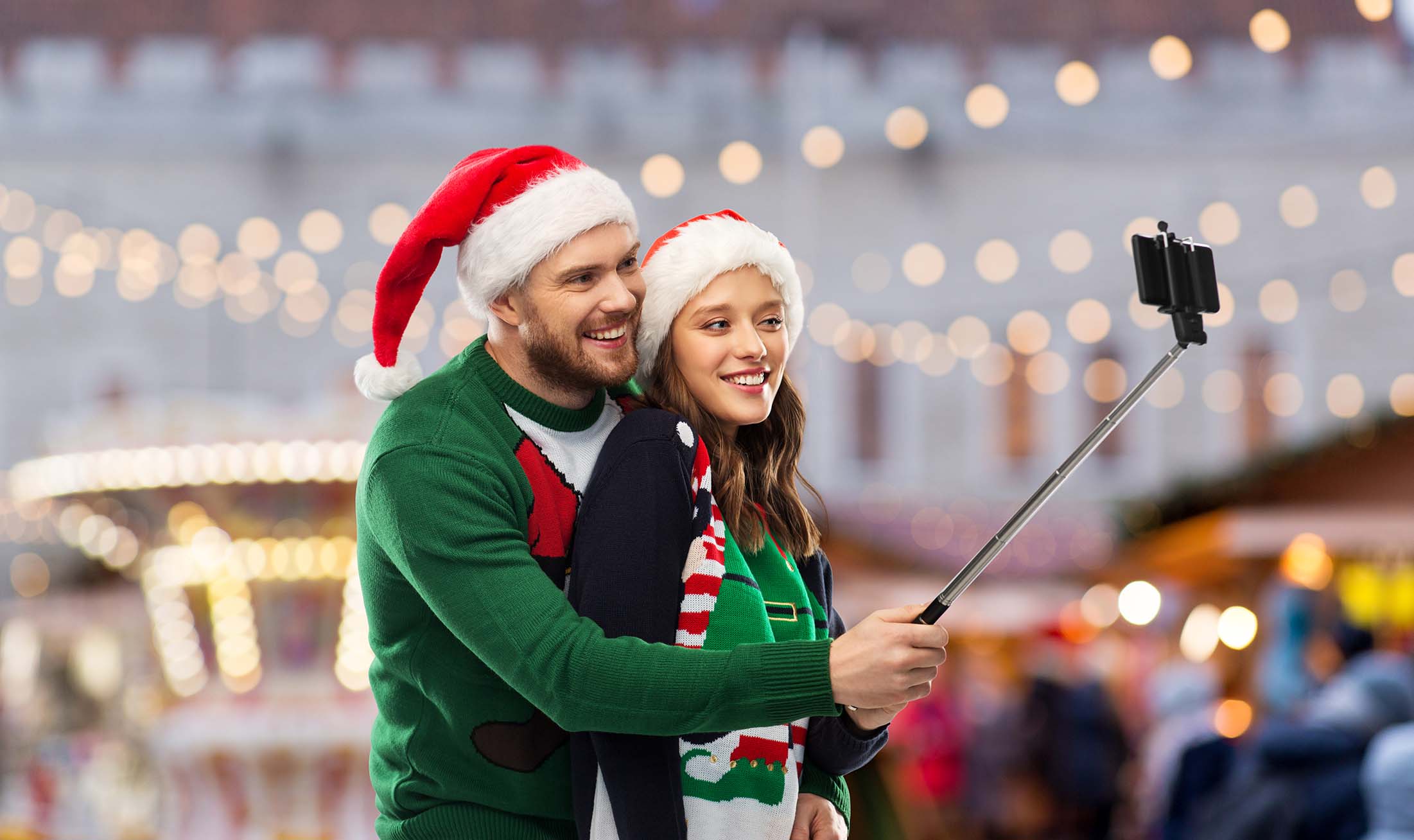 Couple using self stick to get content ready for holiday social media trends