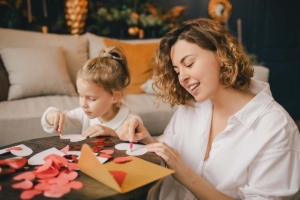 Mother and daughter making valentines day crafts. Marketing ideas for Valentine's