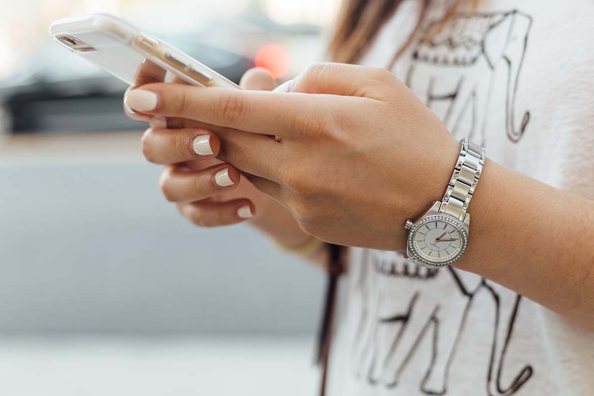 Person holding a phone, engaging in social commerce as it drives sales