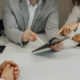 An outsourced marketing team working together on a tablet